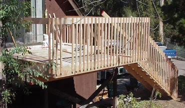 A newly built second-story deck of light wood